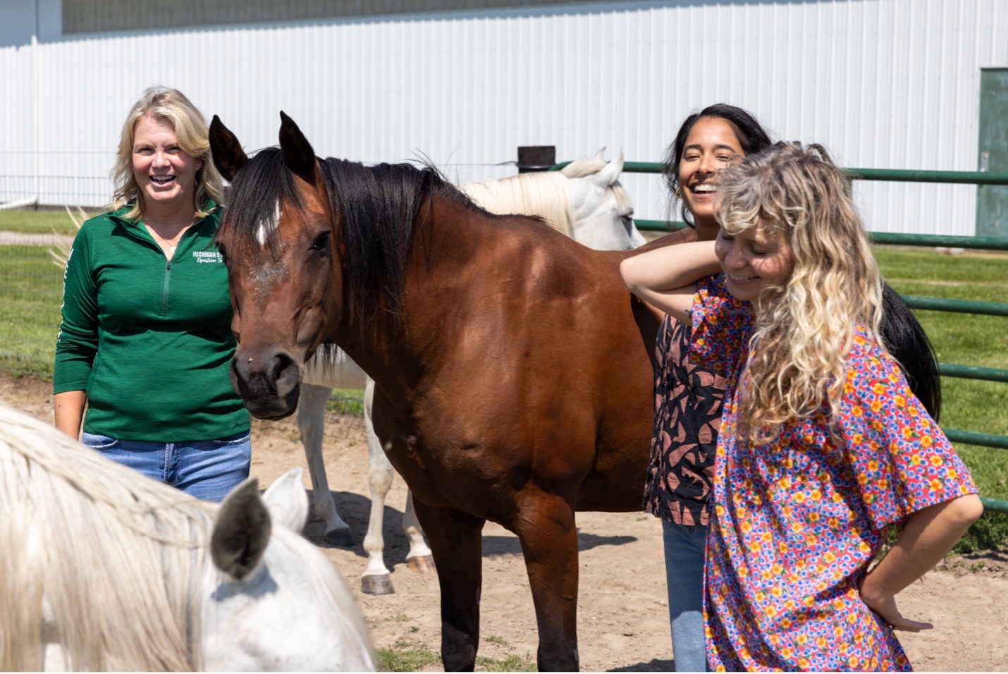 Dr. Karen Waite, Lauren Enty, and Christian Gibson interacting with horses at MSU Horse Teaching & Research Center.